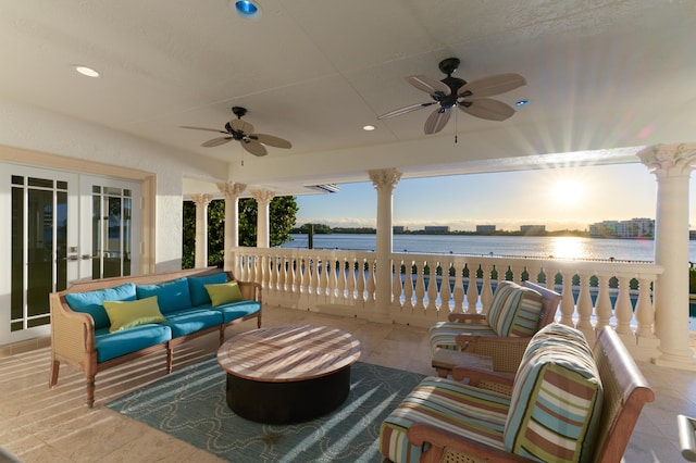 view of patio / terrace featuring an outdoor hangout area, ceiling fan, french doors, and a water view