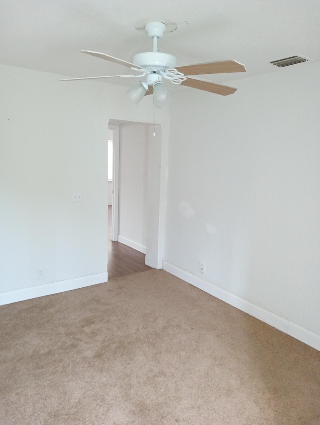 carpeted empty room with ceiling fan