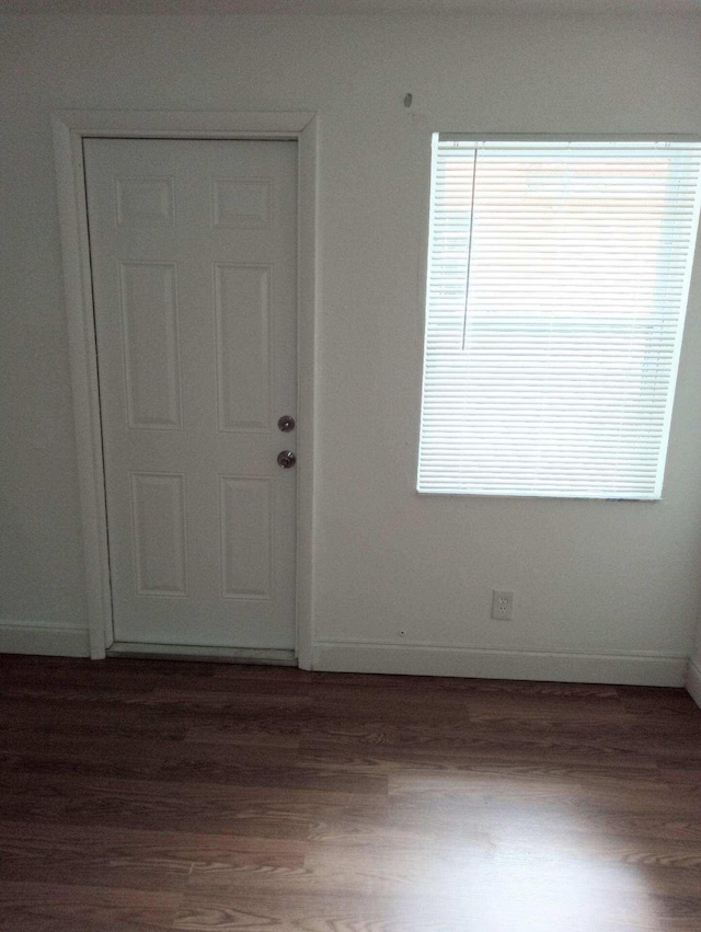 empty room with dark hardwood / wood-style floors