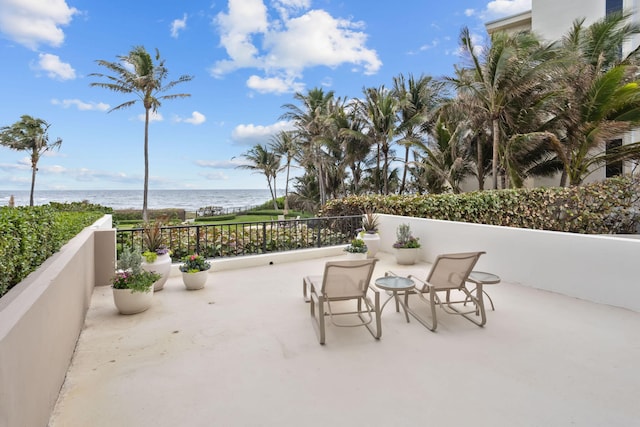 view of terrace with a water view and a balcony