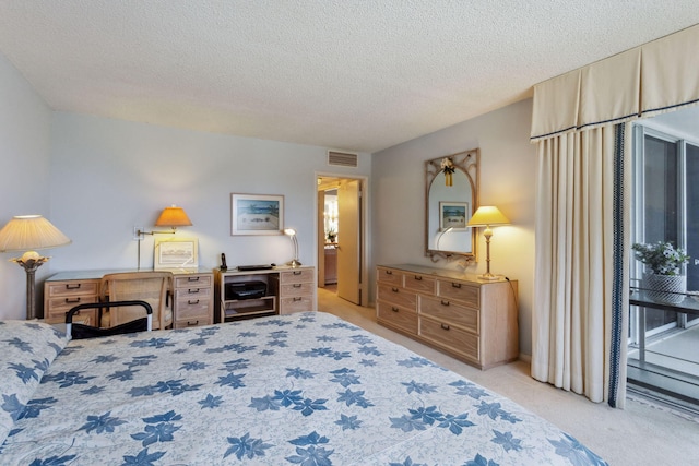 carpeted bedroom featuring a textured ceiling and access to outside