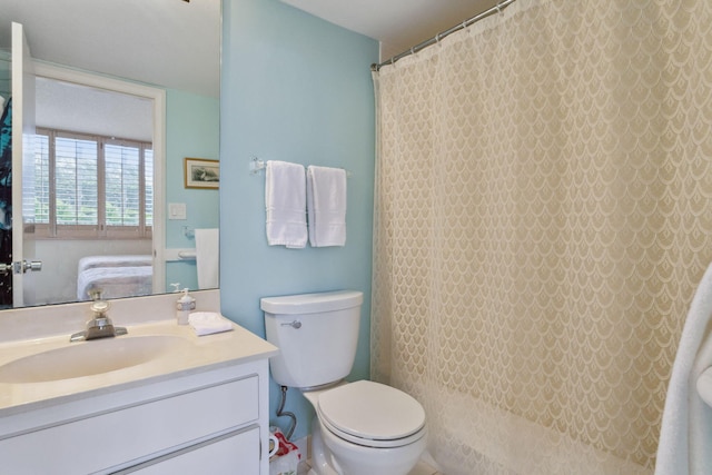 bathroom featuring large vanity and toilet