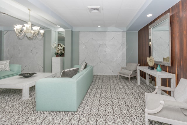 interior space with tile patterned floors, a notable chandelier, wood walls, and a bathing tub