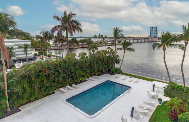 view of pool featuring a patio area and a water view