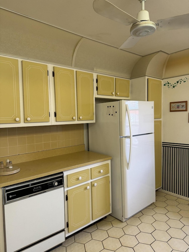 kitchen featuring white cabinetry, tasteful backsplash, and white appliances