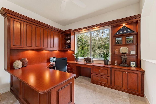 tiled home office with built in desk and ceiling fan