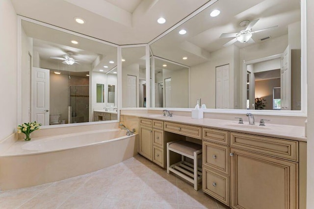 bathroom with double sink, ceiling fan, tile flooring, vanity with extensive cabinet space, and separate shower and tub