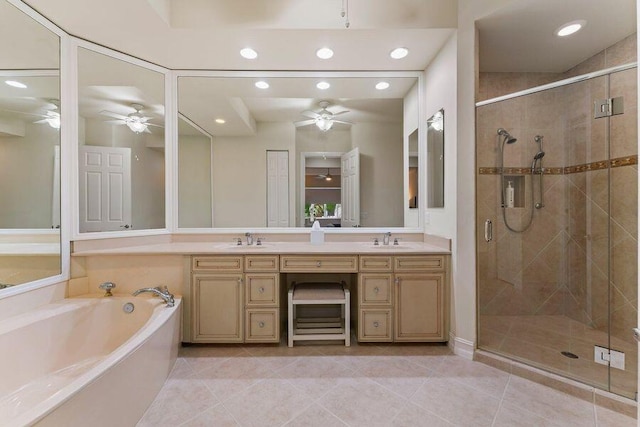 bathroom with tile flooring, dual sinks, ceiling fan, and separate shower and tub