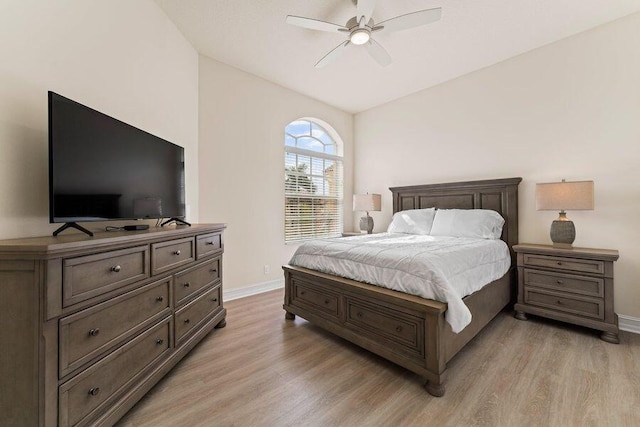 bedroom with lofted ceiling, ceiling fan, and light wood-type flooring