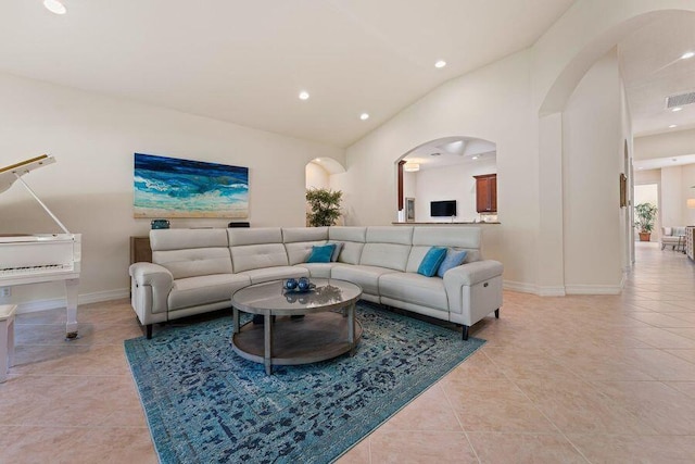 living room with light tile floors and lofted ceiling