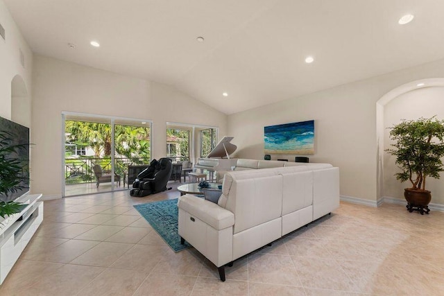 living room featuring high vaulted ceiling and light tile flooring