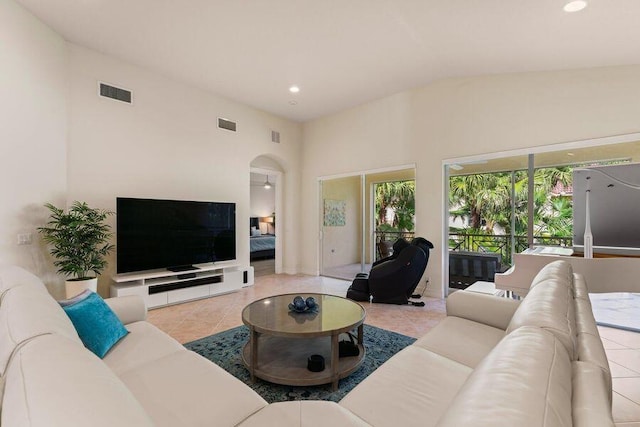 tiled living room with lofted ceiling