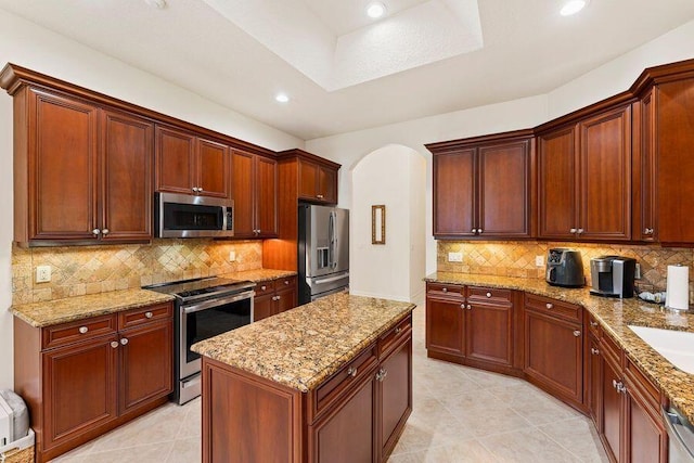 kitchen with backsplash, appliances with stainless steel finishes, and light tile floors