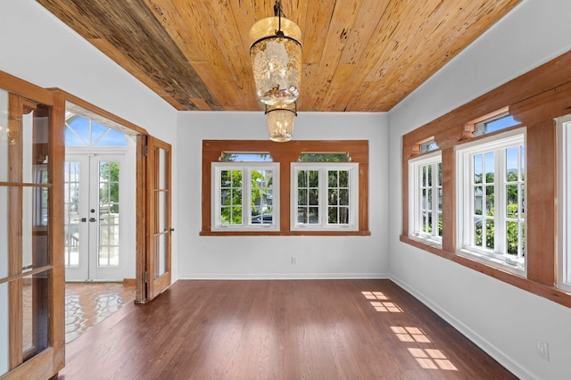 unfurnished sunroom with wooden ceiling, french doors, a healthy amount of sunlight, and a notable chandelier