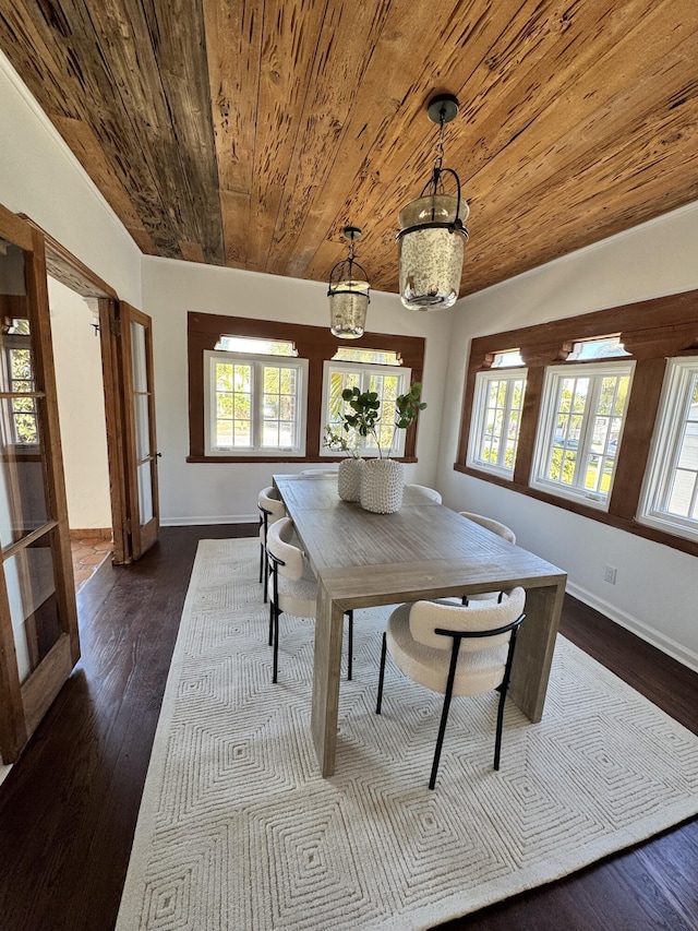 unfurnished dining area with french doors, dark hardwood / wood-style flooring, an inviting chandelier, and a healthy amount of sunlight