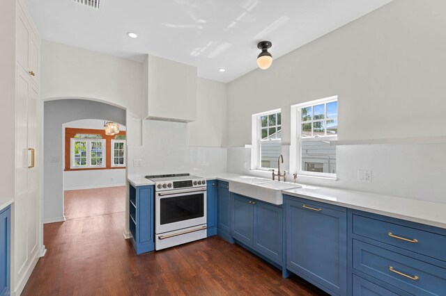 kitchen with dark hardwood / wood-style floors, sink, blue cabinets, and white stove