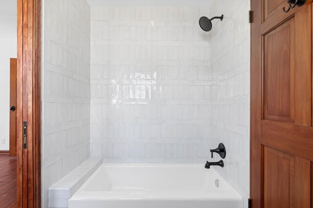 bathroom featuring hardwood / wood-style floors and tiled shower / bath combo