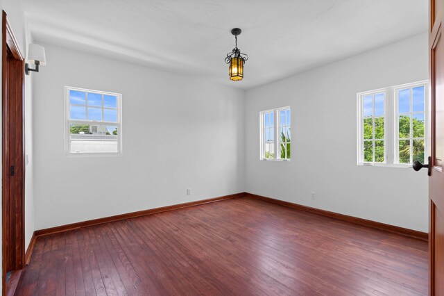 unfurnished room with dark hardwood / wood-style floors