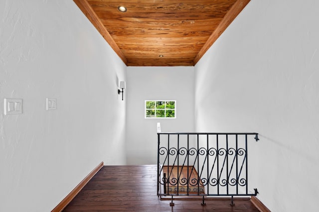 staircase featuring hardwood / wood-style floors and wooden ceiling