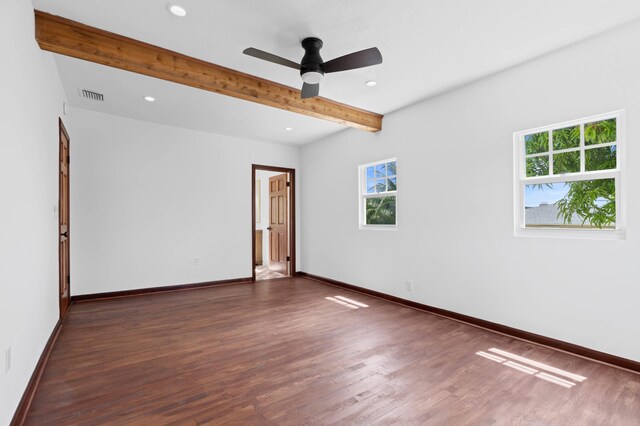 unfurnished room featuring beam ceiling, ceiling fan, and dark wood-type flooring