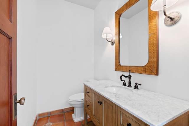 bathroom featuring tile patterned floors, vanity, and toilet