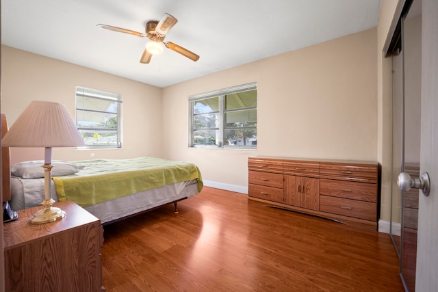 bedroom featuring pool table, a closet, ceiling fan, and dark hardwood / wood-style flooring