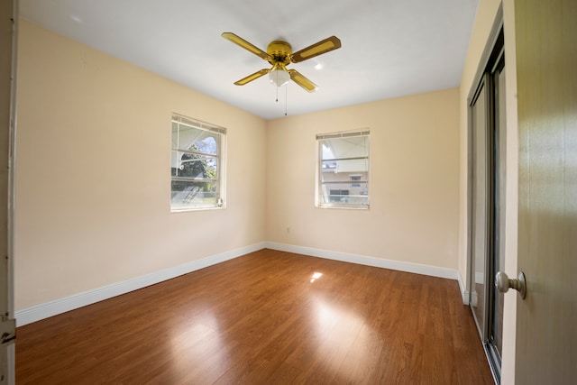 spare room with ceiling fan and dark hardwood / wood-style floors