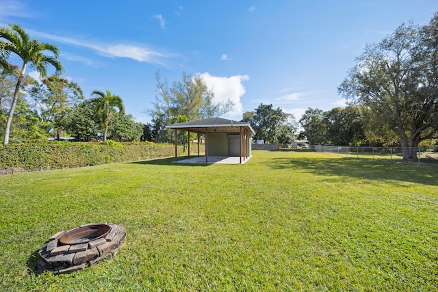 view of yard with a patio and a fire pit