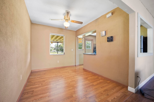 unfurnished room with light hardwood / wood-style floors and ceiling fan