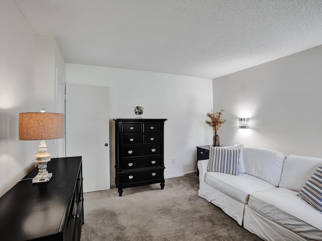 carpeted living room featuring a textured ceiling