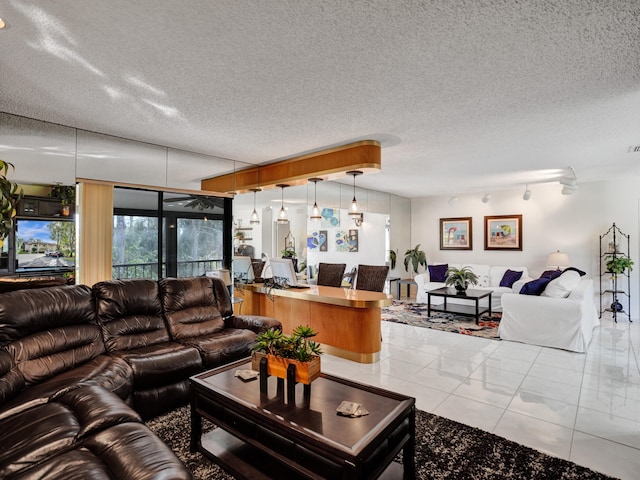 tiled living room featuring a textured ceiling and track lighting