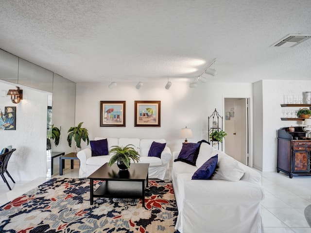 tiled living room with a textured ceiling and rail lighting