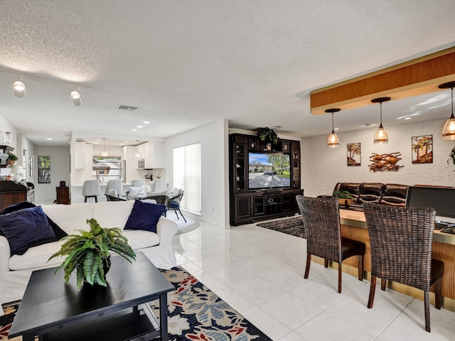 living room with light tile floors and a textured ceiling