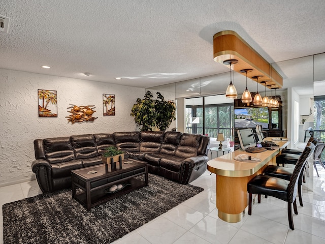 living room with a chandelier, light tile floors, and a textured ceiling