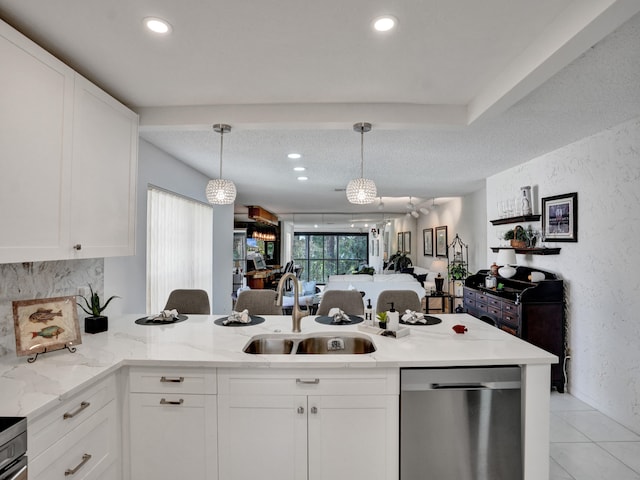 kitchen with white cabinets, decorative light fixtures, dishwasher, and sink