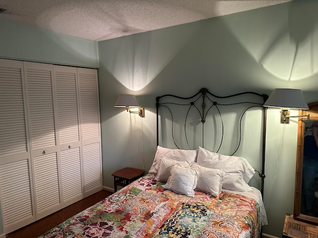 bedroom with a closet and a textured ceiling