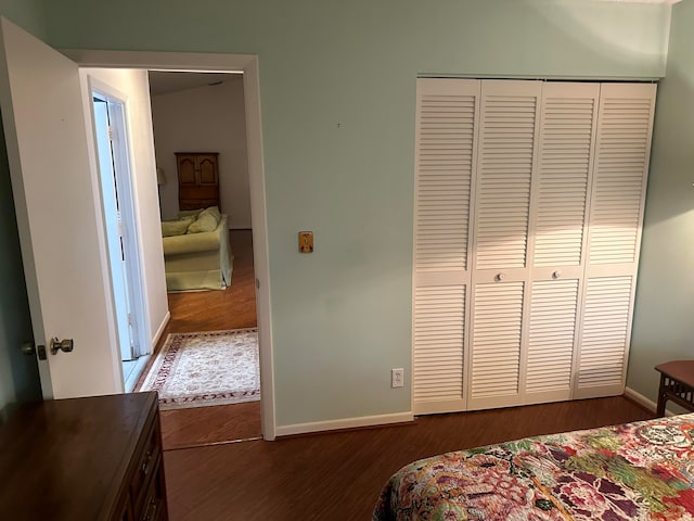 bedroom featuring a closet and dark hardwood / wood-style floors