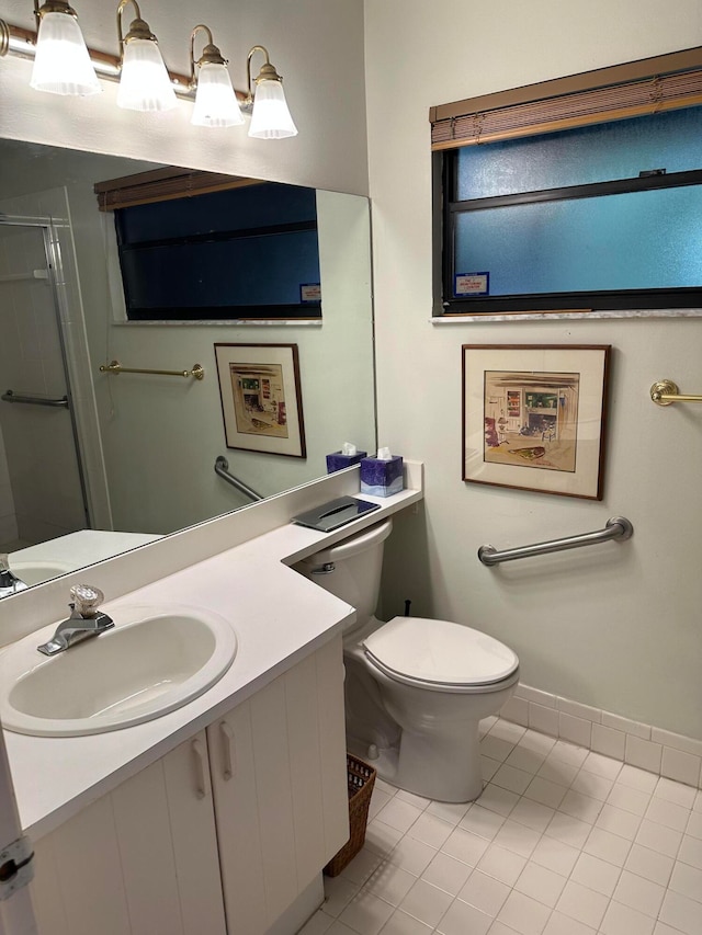 bathroom with tile floors, vanity with extensive cabinet space, and toilet