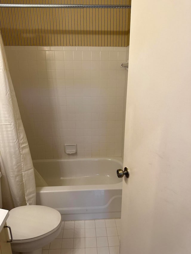 full bathroom with shower / bath combo with shower curtain, toilet, vanity, and tile flooring