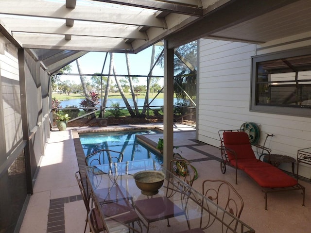 view of swimming pool with glass enclosure and a patio area