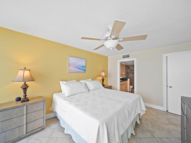 bedroom featuring connected bathroom, ceiling fan, and light tile flooring