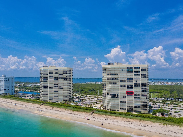 view of property with a view of the beach and a water view