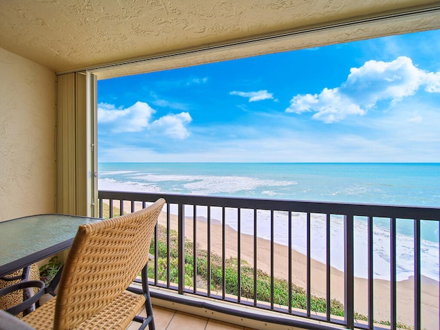 balcony with a beach view and a water view