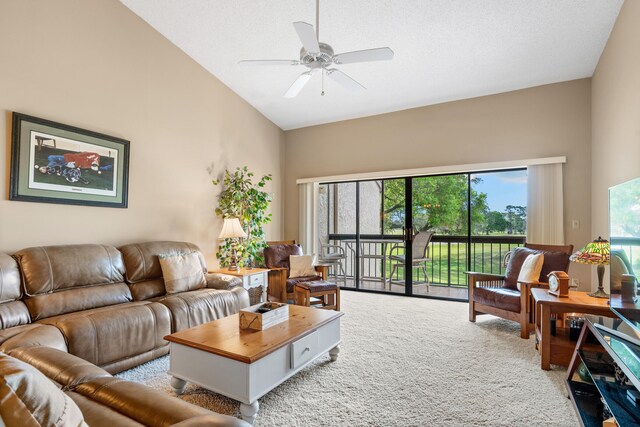 carpeted living room featuring ceiling fan and high vaulted ceiling