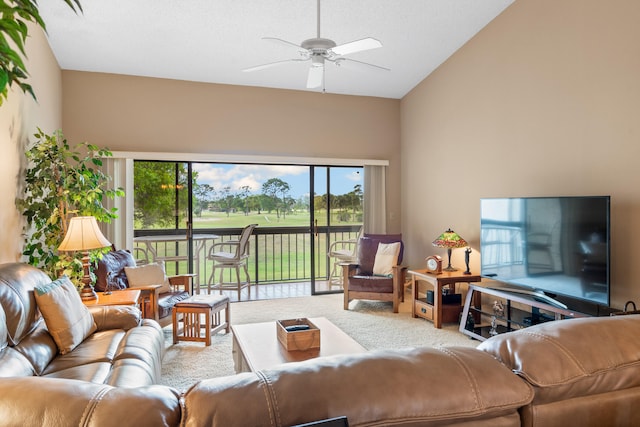 carpeted living room featuring high vaulted ceiling and ceiling fan