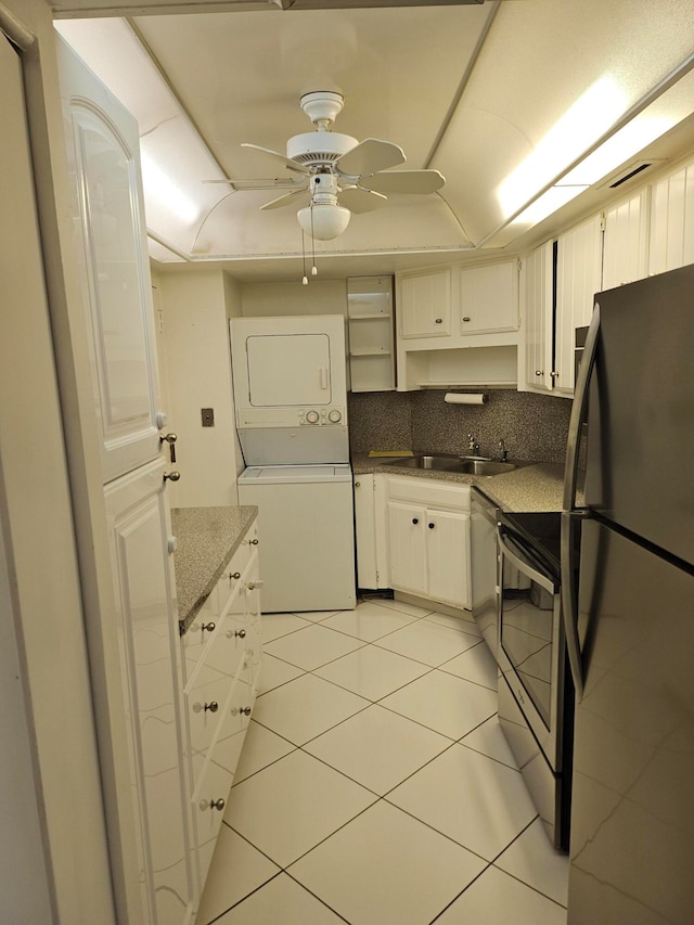 kitchen with ceiling fan, sink, stainless steel appliances, light tile flooring, and white cabinetry