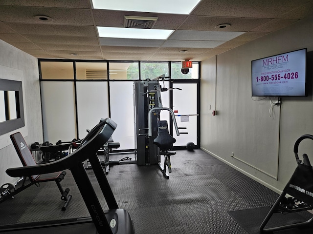 workout area featuring a paneled ceiling