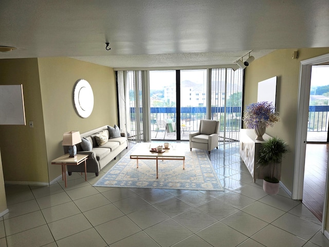 living room with a textured ceiling and light tile flooring