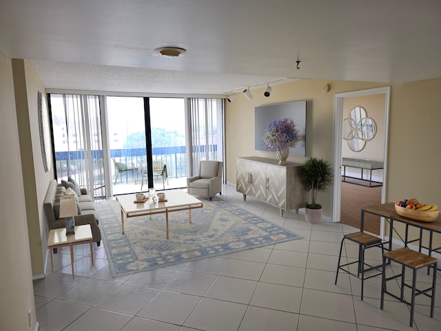 living room with track lighting, a textured ceiling, and light tile flooring