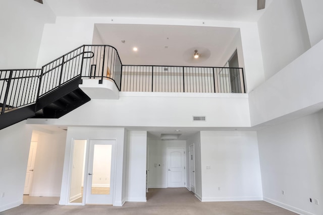 stairway with a towering ceiling